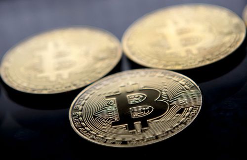 Gold-plated souvenir Bitcoin coins are arranged for a photograph in London in November 2017. Bitcoin hit a new record above $80,000 on November 10.