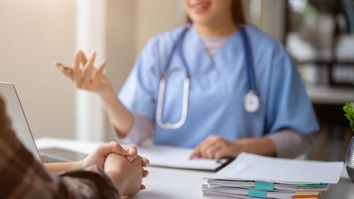 Close-up hand image of a serious patient having a medical consultation with a professional doctor at a hospital. Medical checkup, counseling, and diagnosis of disease