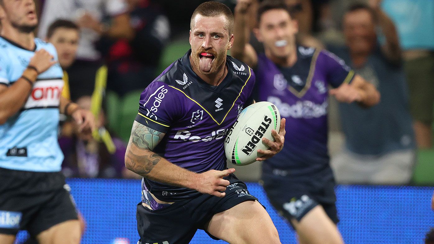 Cameron Munster of the Storm celebrates on his way to scoring a try