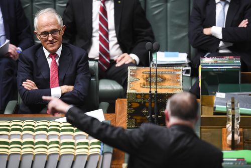 Prime Minister Malcolm Turnbull reacts as he listens to Shadow Infrastructure Minister Anthony Albanese during House of Representatives Question Time at Parliament House