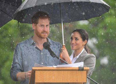 Prince William and Kate Middleton shelter under an umbrella at Royal Ascot