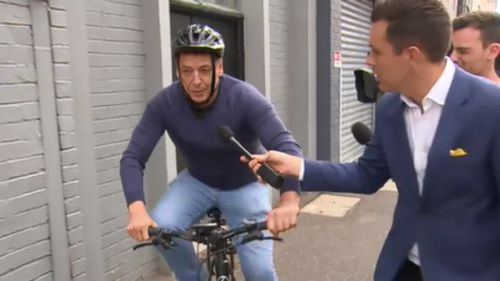 "I'm sorry," the ex-Essendon coach said as he rode away on his push-bike. (9NEWS)