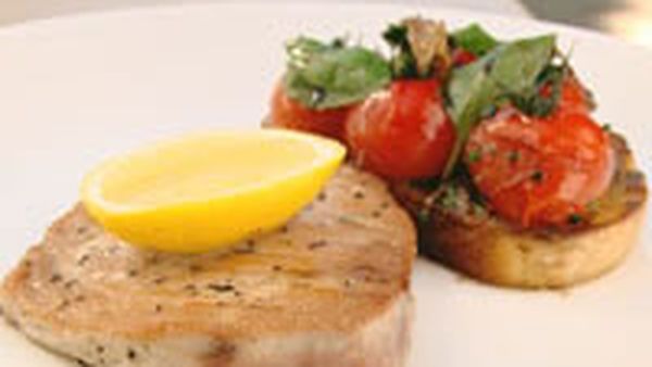 Seared tuna steak with sauteed tomatoes, basil toast and anchovy butter