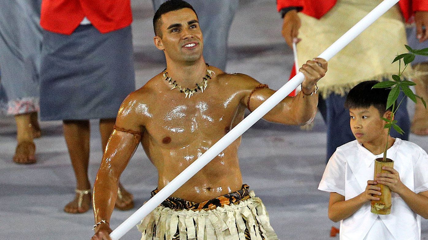  Flag bearer Pita Nikolas Aufatofua of Tonga leads his Olympic Team