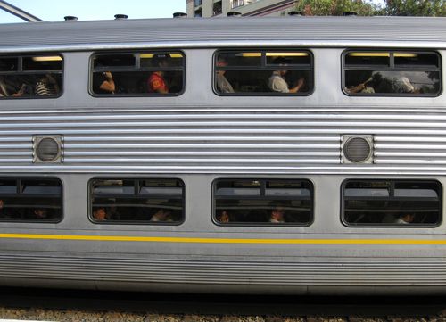 Commuters experienced lengthy delays after a man was filmed hanging from overhead wires at Redfern Train Station.