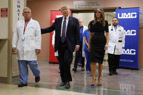  President Donald Trump and first lady Melania Trump walk through University Medical Center after meeting with victims of the mass shooting. (AAP)