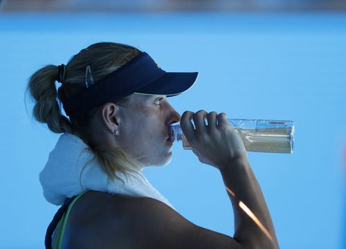 Angelique Kerber of Germany cools down with a drink during a break in her second round match against Donna Vekic of Croatia at the Australian Open Grand Slam. (AAP)