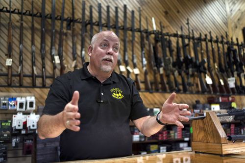 Rick LaChapelle, owner of Coastal Trading and Pawn, is seen at the counter of his gun shop in Auburn, Maine, in this July 18, 2022, file photo. 