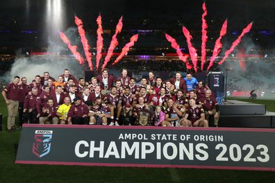Queensland players and support staff celebrate series victory following game three of the State of Origin.