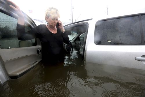 Rhonda Worthington talks on her cell phone with a 911 dispatcher after her car became stuck in rising floodwaters. (AP)