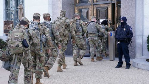 National Guard walk into the Dirksen Senate Office Building near the Capitol.