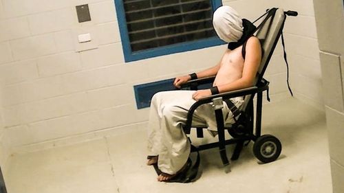 An image from the vision of Mr Voller being strapped into the chair and spit-hooded which sparked the royal commission into juvenile detention. (Image: ABC)