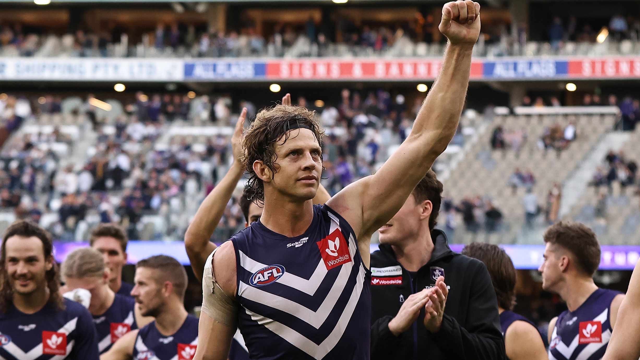 PERTH, AUSTRALIA - JUNE 11: Nat Fyfe of the Dockers leads the team from the field after winning the round 13 AFL match between the Fremantle Dockers and the Hawthorn Hawks at Optus Stadium on June 11, 2022 in Perth, Australia. (Photo by Paul Kane/Getty Images)