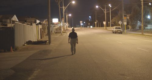 John Button is pictured walking on a Perth street near the location where his girlfriend, Rosemary Anderson, was run down by a car and killed.