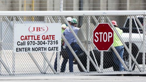 Employees in the carpark of the JBS Beef Production Facility in Greeley, Colorado.