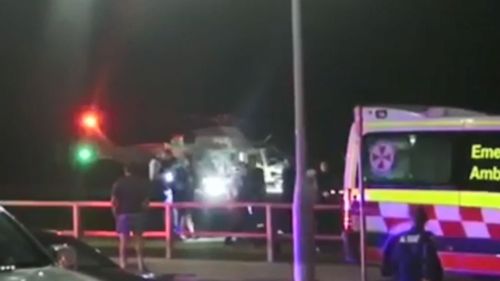 The rescue helicopter lands with the two divers on a Sydney beach where the women were treated by paaramedics.