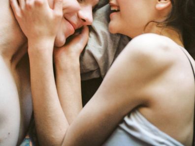 Stock photo of a woman and man in bed together.