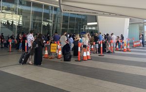 Long delays at Adelaide testing clinics as locals rush home from Brisbane