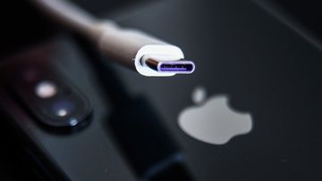 USB-C cable and Apple logo on iPhone are seen in this illustration photo taken in Krakow, Poland on September 25, 2021 