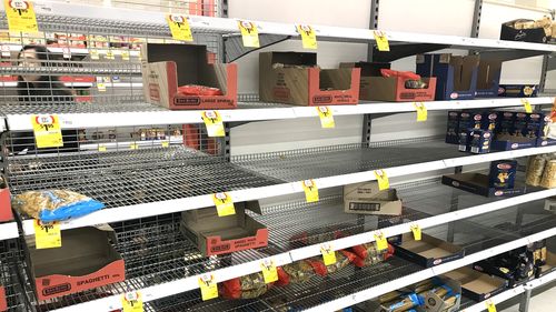 Supermarket shelves emptied of pasta and spaghetti.