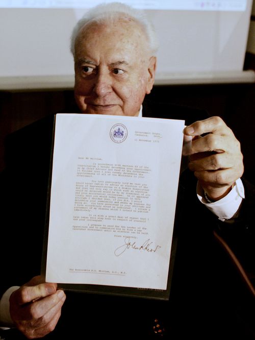 In this November 7, 2005 file photo, former Australian Prime Minister Gough Whitlam holds up the original copy of his dismissal letter he received from then Governor General Sir John Kerr on the 11th of November 1975 at a book launch in Sydney, Australia. Historian, Professor Jenny Hocking, is going to court this month in an attempt to force Australian authorities to release secret letters that would reveal what Queen Elizabeth II knew of her representative's sho