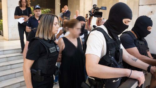 	Greek police lead the ex-wife of murdered UC Berkeley professor Przemyslaw Jeziorski to court in Athens on July 17, alongside her new boyfriend and three others alleged to be involved in the Polish educator's shooting on July 4. CNN has added blur to this image.