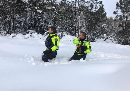 Two search and rescue team members plough through deep snow in Tasmania hunting for missing hiker Michael Bowman. Three police search and rescue teams, the Westpac Rescue Helicopter, a police marine vessel and a team of SES volunteers, are currently searching for the 57 year old Victorian man, who is an experienced bushwalker.
