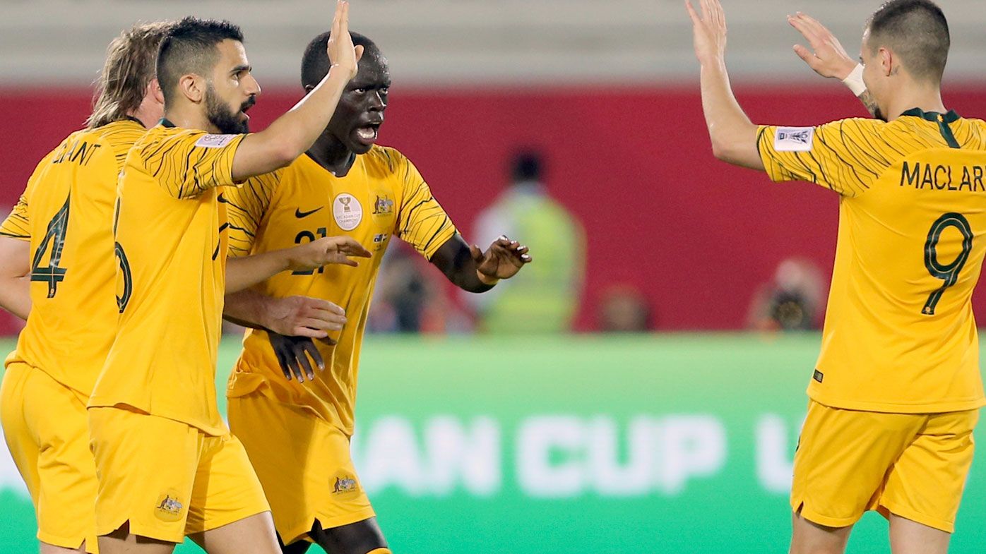Australia's midfielder Awer Mabil celebrates with teammates after scoring his side's opening goal during the AFC Asian Cup match against Syria in Al Ain, United Arab Emirate.