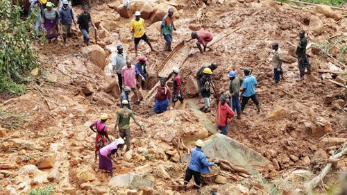 A family dig for their son who got buried in the mud when Cyclone Idai struck in Chimanimani about 600 kilometres south east of Harare, Zimbabwe, Tuesday, March, 19, 2019.