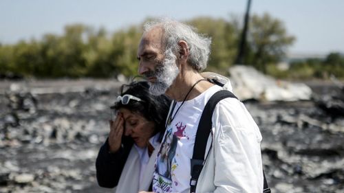 Grieving parents lay flowers at MH17 crash site