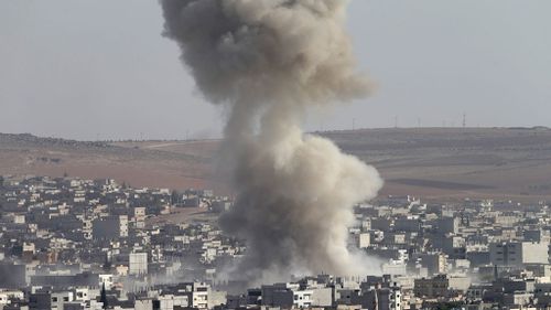 A picture taken from Turkey showing smoke rising from Kobane after an apparent airstrike during clashes between Islamic State and Kurdish fighters. (AAP)