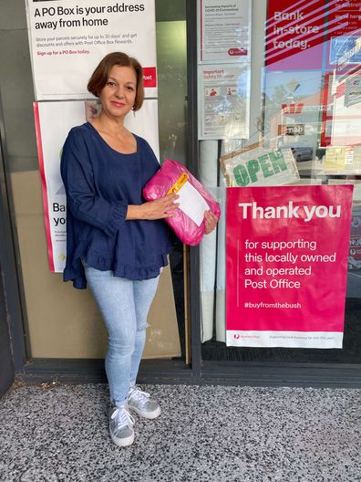 Fashion boutique owner Krys Charalambous drops off an order at her local post office.