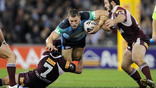 New South Wales' Luke O'Donnell is tackled by Queensland's Johnathan Thurston and Dallas Johnson in the first game of the 2009 State of Origin series. Picture: AAP