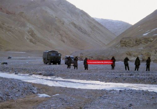  In this May 5, 2013 file photo, Chinese troops hold a banner which reads, "You've crossed the border, please go back," in Ladakh, India.
