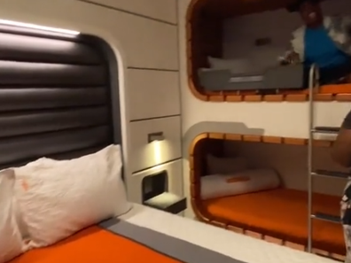 Carina Ja showing the bed and bunk beds or 'cubbies' in the cabin room.