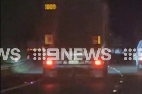 Vision supplied to 9News shows metal debris trailing a truck on the M1.