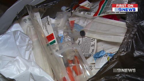 Syringes covering the floor of the property. (9NEWS)