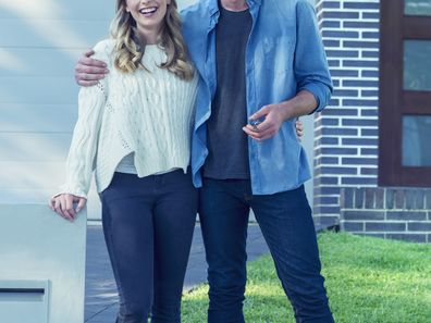 Young couple in front of home