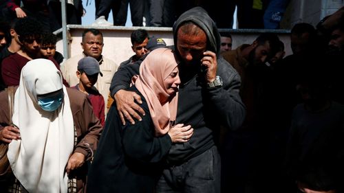 The mourners react next to the bodies of the Palestinians killed in an Israeli strike in the strip of northern Gaza on March 15.