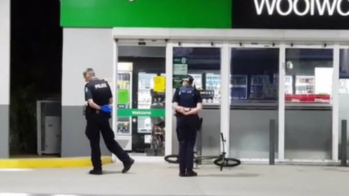 Police at the service station where the man rode for help.