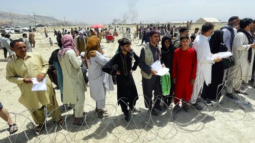 In this August 17  file photo hundreds of people gather outside the international airport in Kabul, Afghanistan. 