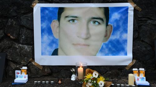 A shrine under a photo of deceased detainee Reza Berati, who was killed on Manus Island. (Supplied)