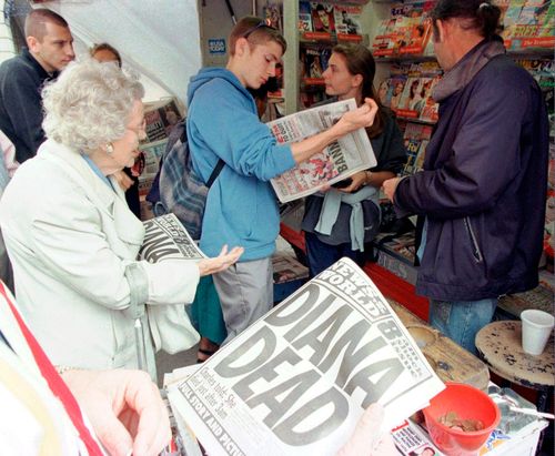 Londoners buy Sunday newspapers reporting the death of Diana, Princess of Wales