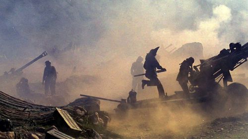 Indian artillery guns are engulfed in smoke in Dras, some 155 kilometers (96 miles) north of Srinagar, India, as Indian troops fight Pakistani intruders in the disputed Kashmir on July 10, 1999. (AP Photo/Aijaz Rahi, File)