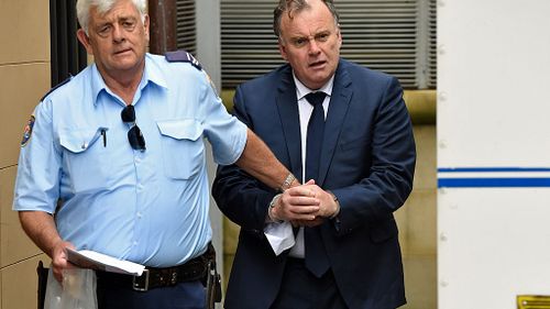 Glen McNamara (right) is escorted by a correctional services officer as he leaves the NSW Supreme Court in Sydney on Wednesday, Feb. 3, 2016 (AAP)
