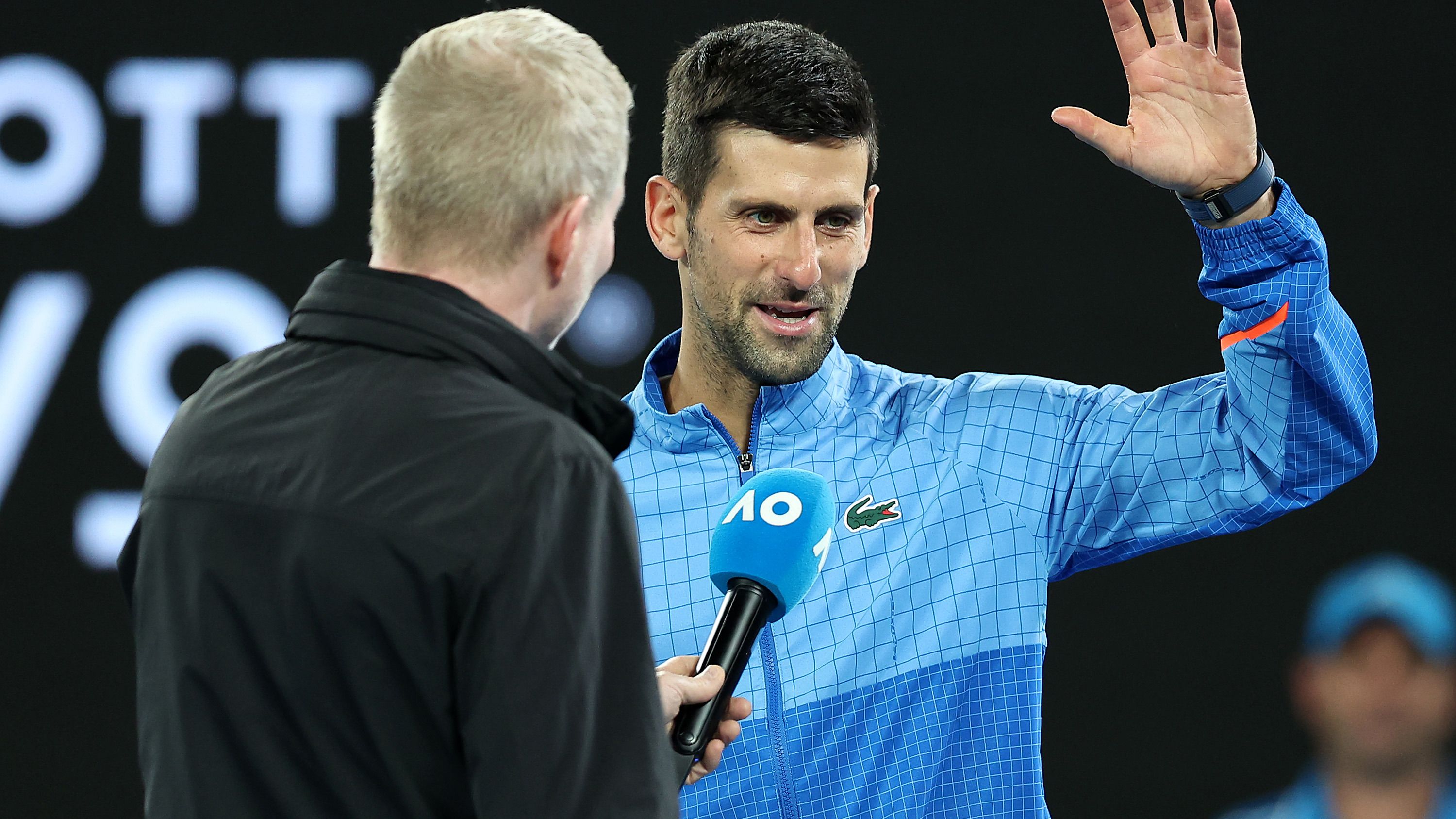 Novak Djokovic of Serbia is interviewed by Jim Courier after his quarter final. (Photo by Cameron Spencer/Getty Images)