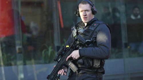 An armed police officer outside Borough Market after an incident on London Bridge in central London following a police incident, Friday, Nov. 29, 2019