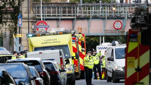 Ambulances and police stand nearby after the explosion on a tube train at Parsons Green subway station in London. (Image: AAP)