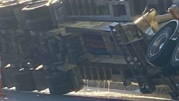 A truck has rolled on a road in Auckland, spilling glue.