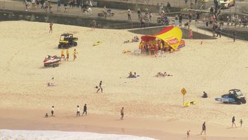 A man has been pulled unconscious from the water at Bondi in Sydney&#x27;s east as people flock to the beach on a sunny public holiday.